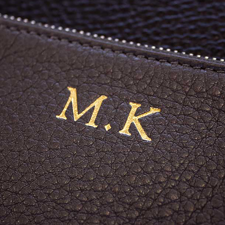 Monogrammed initials on leather wallet and accessories